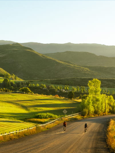 two people biking in mountains