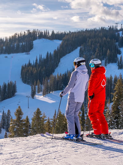 ski instructor with skier at snowmass