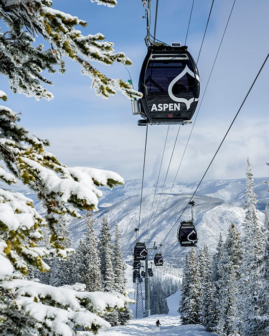 Aspen gondola on snowy mountain