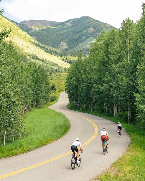 people road biking up mountain road