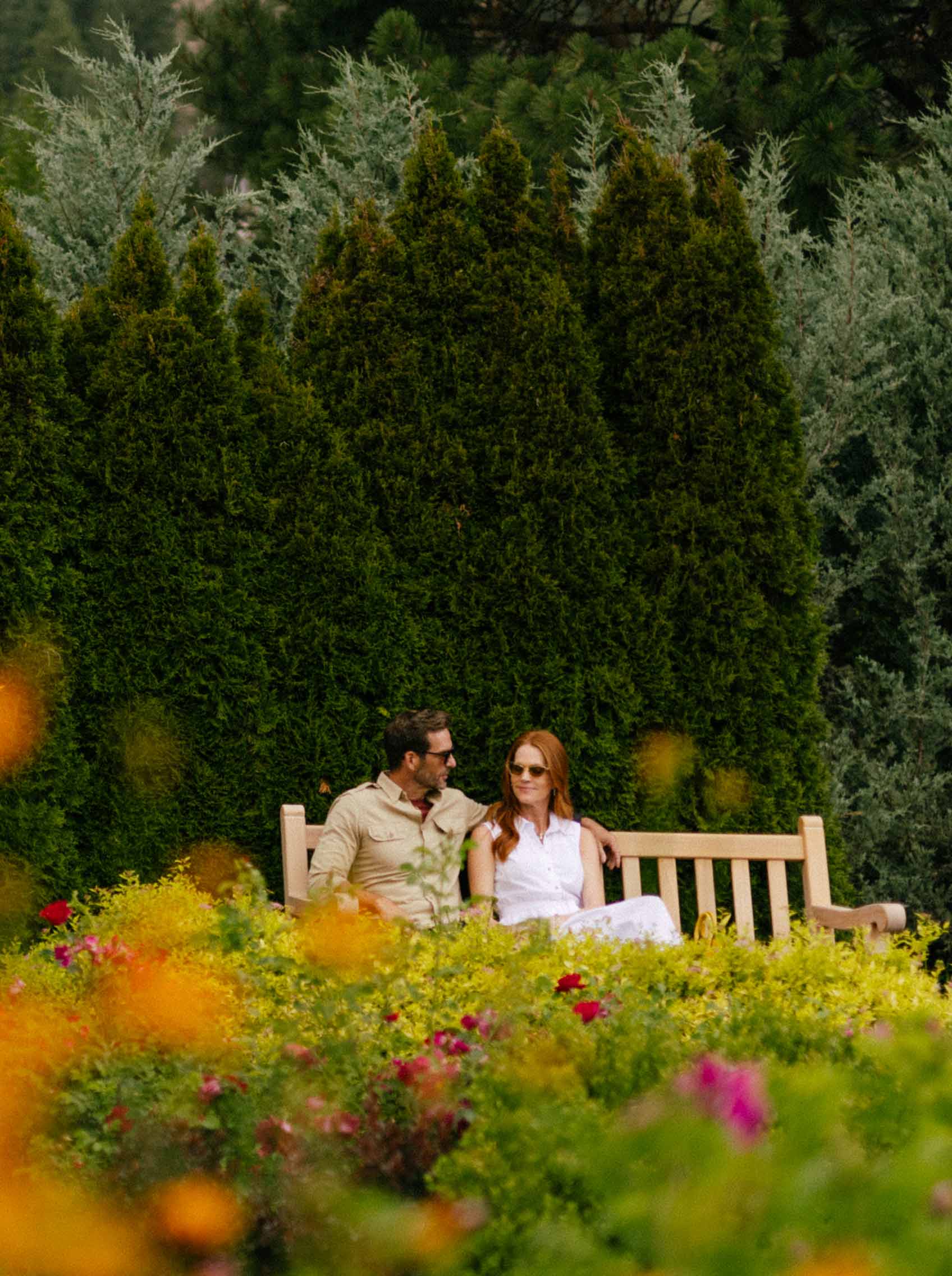 couple sitting on bench in garden