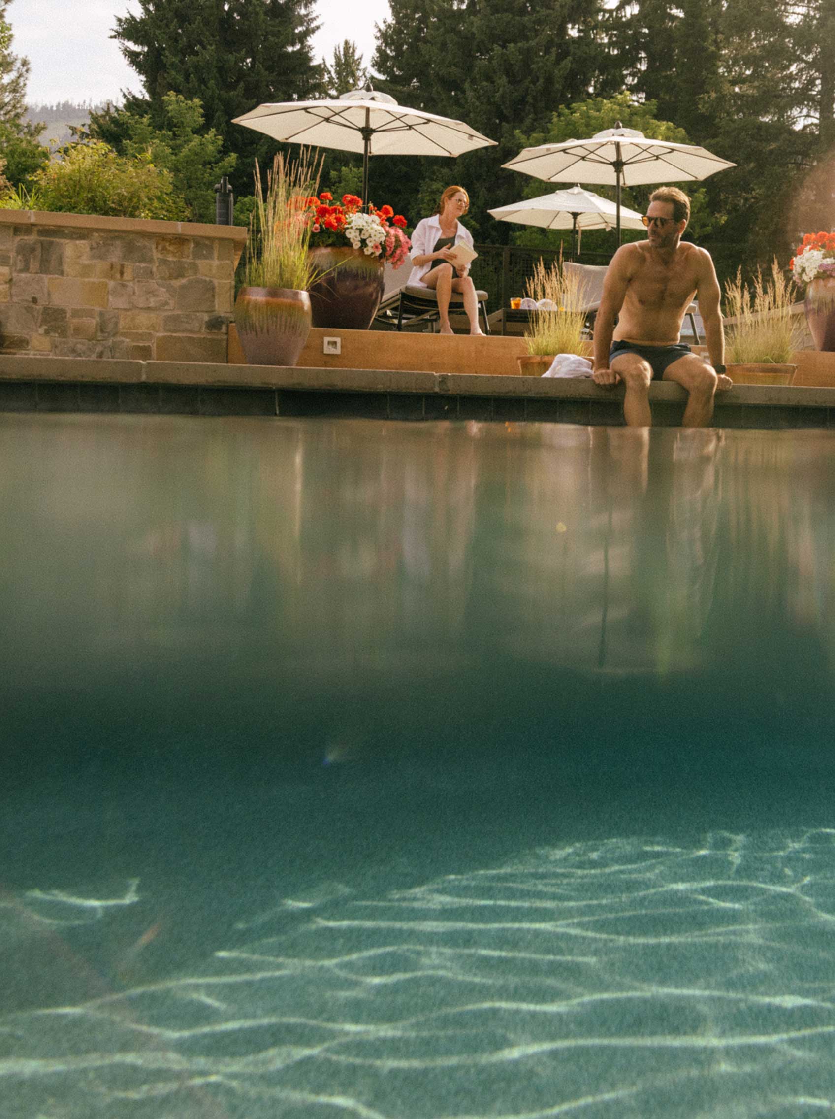 man sitting at edge of pool at limelight ketchum