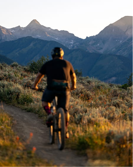 person mountain biking in snowmass