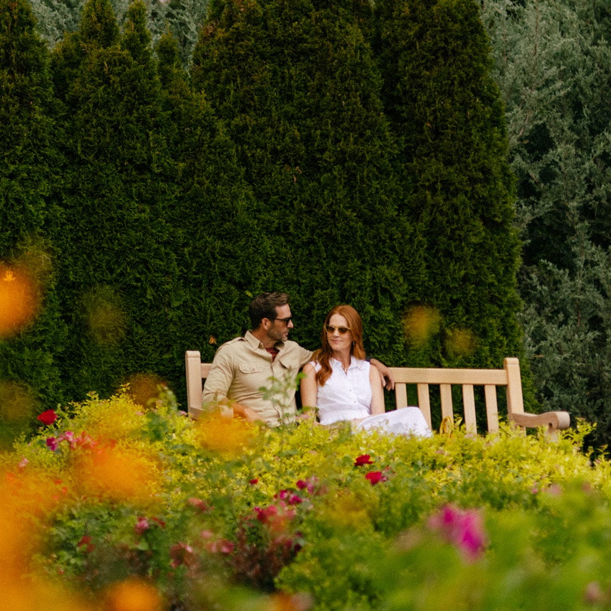 couple sitting on bench in garden