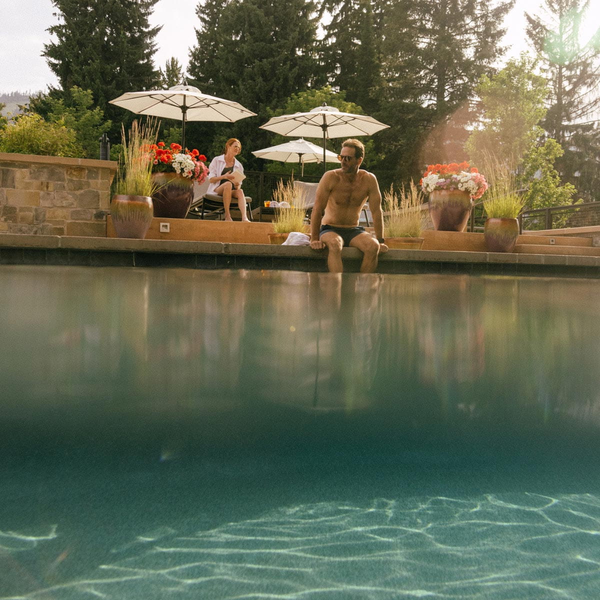 man sitting on edge of pool at limelight ketchum