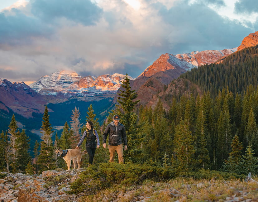 couple with dog hiking in snowmass mountains