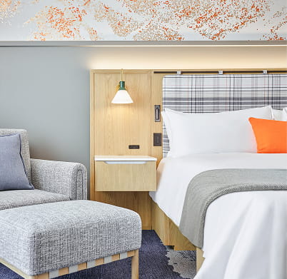 bed and chair in guest room