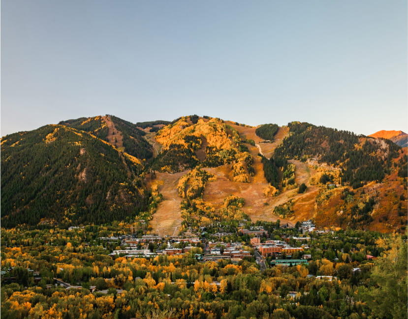 View of Aspen Mountain in the Fall with green and yellow leaves on the mountains