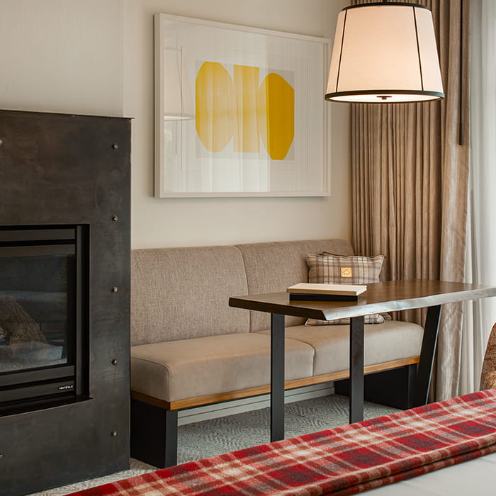 table and fireplace in guest room