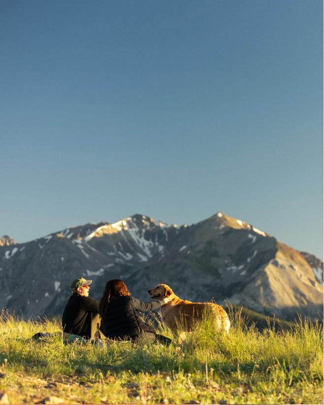 couple with dog in mountain