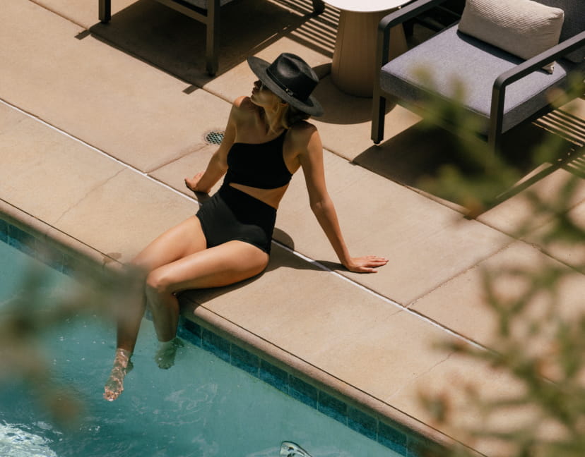 woman sitting by pool at limelight aspen