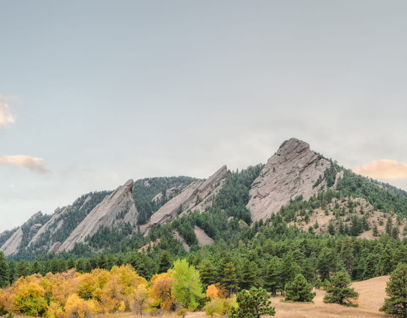 View of mountains in Boulder during the fall with green and yellow foliage