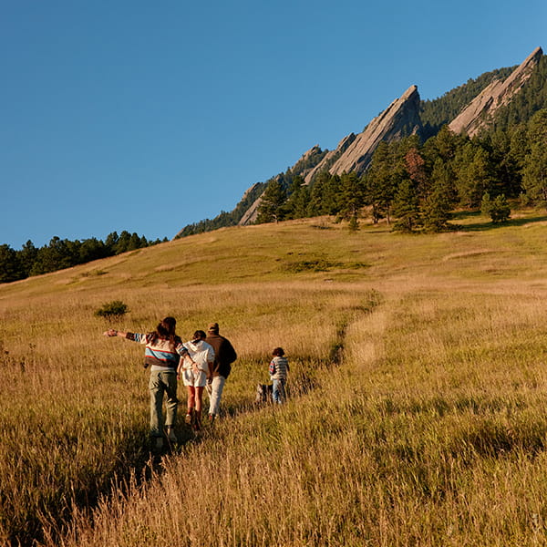 family hiking flatirons in the fall