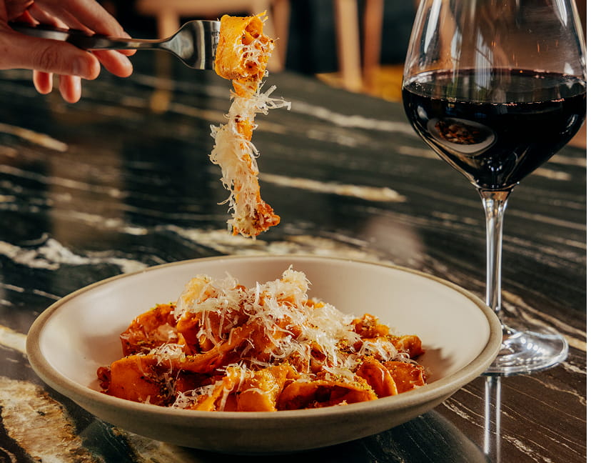 pasta and wine on table in ajax
