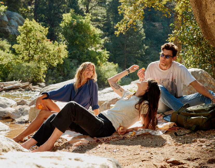 group of friends hanging out by creek