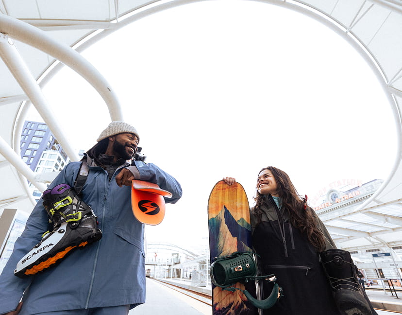 two skiers waiting for winter park express train