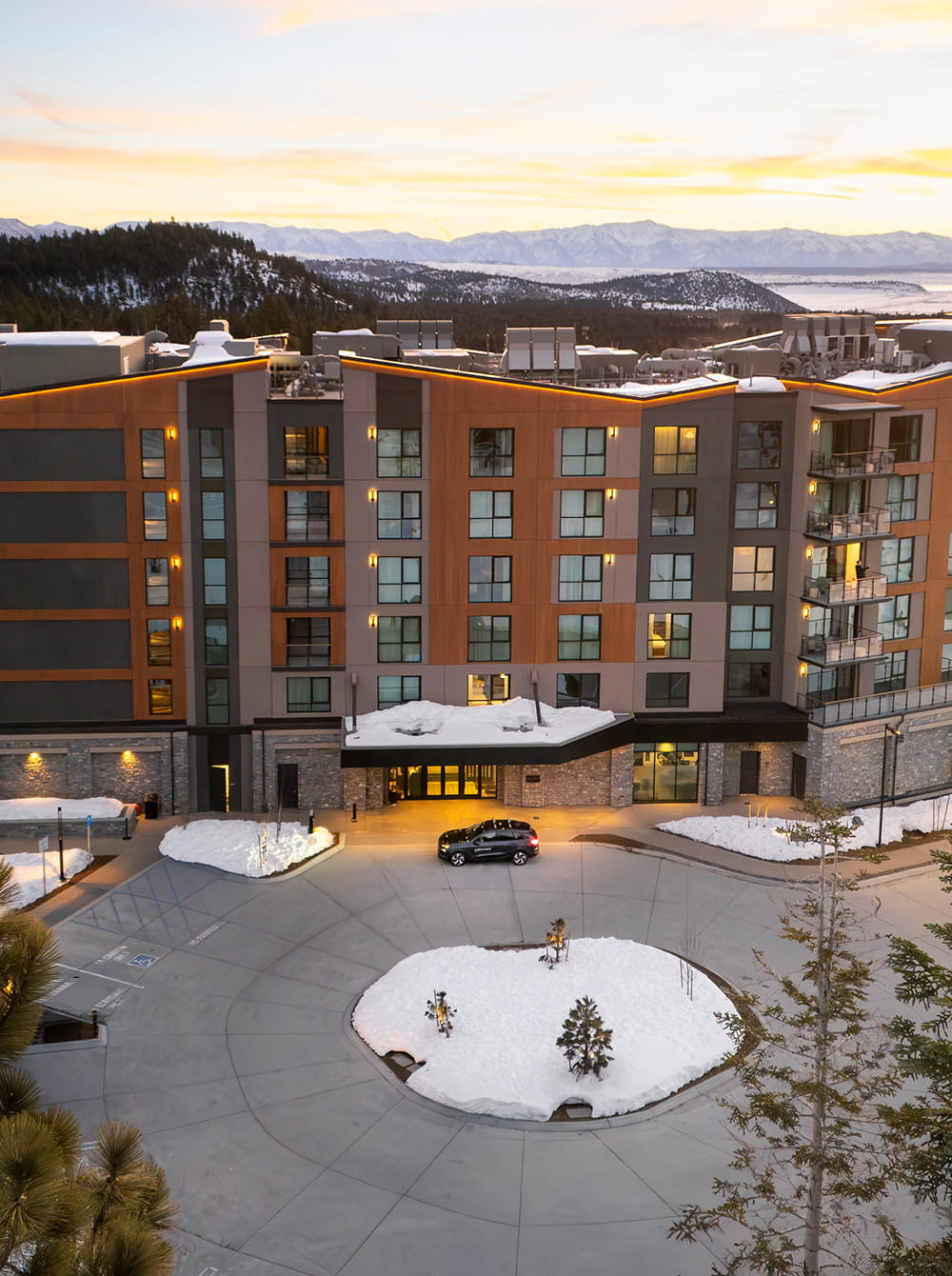 car in front of hotel overlooking mountains