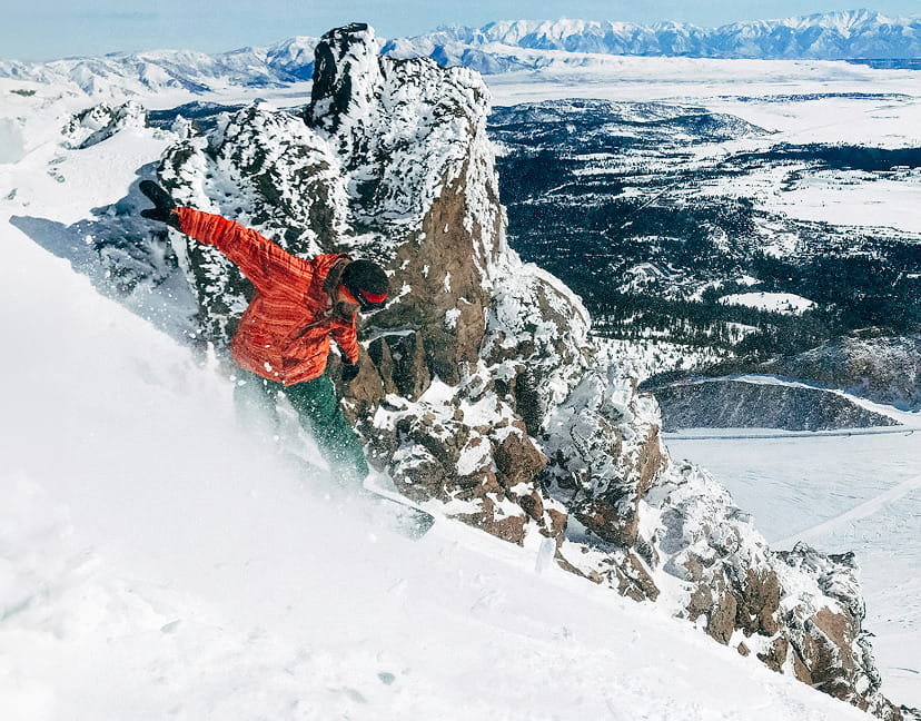 snowboarder riding down mountain