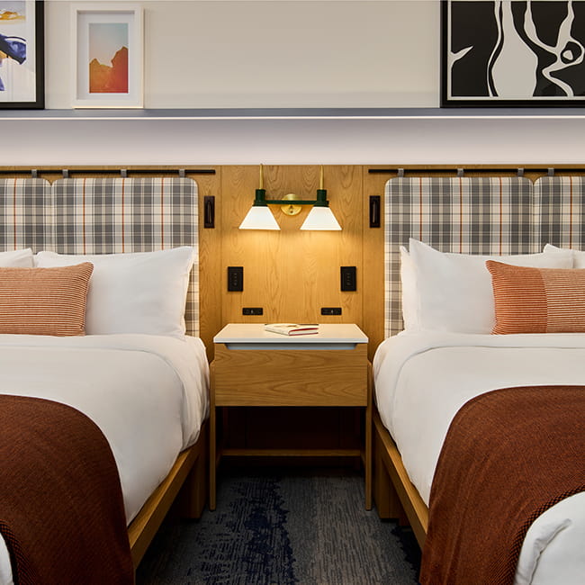 queen beds and night stand in guest room