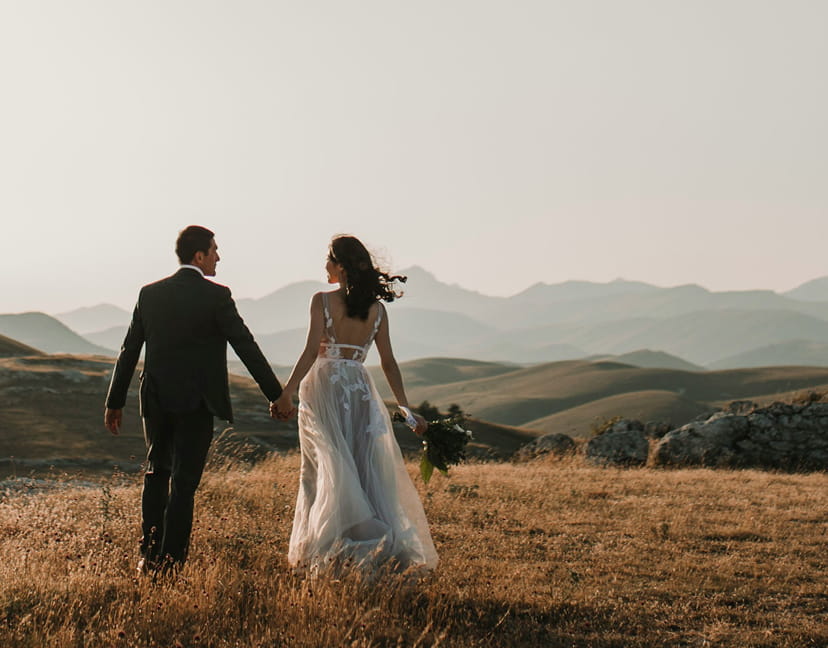 wedding couple walking in mountains