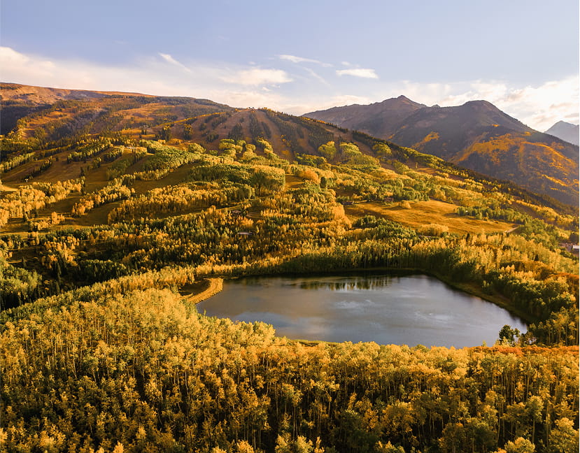 View of a lake and fall foliage in the mountains