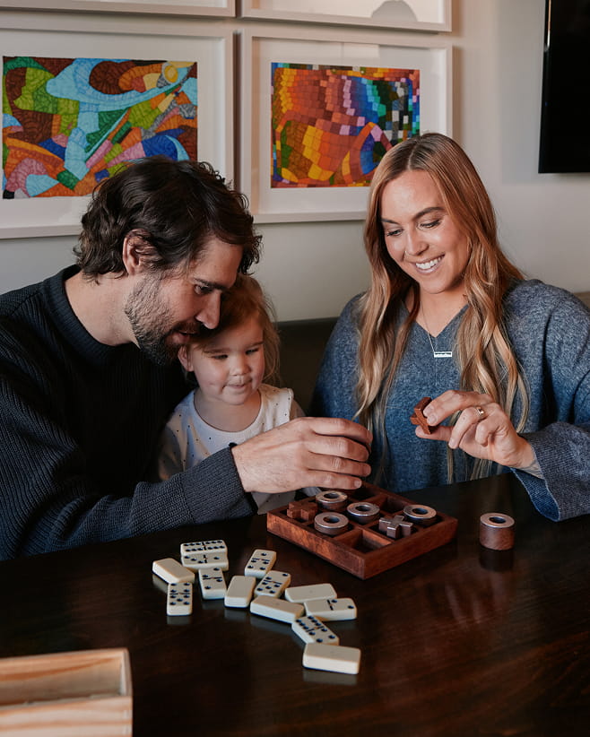 family playing game in guest room