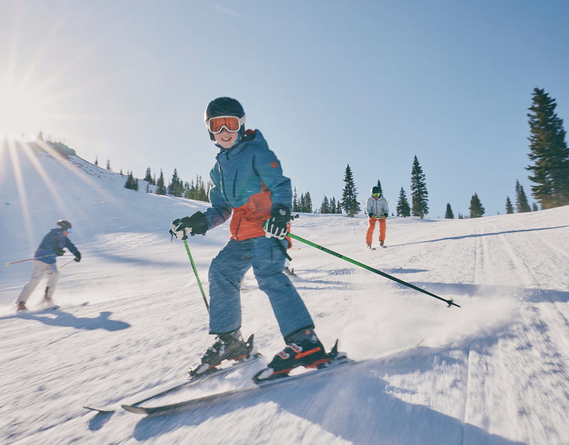 child skiing down mountain