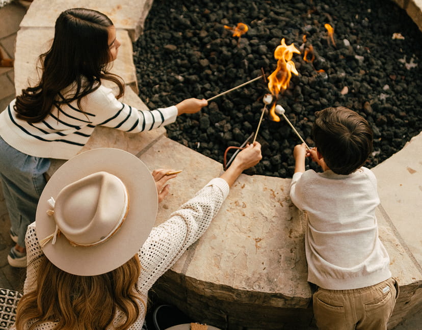 family roasting marshmallows outside