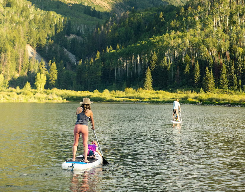 people suping on alpine lake