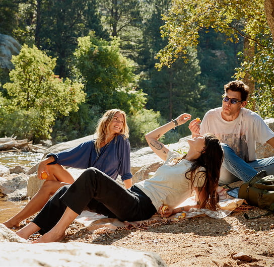 friends hanging out by creek