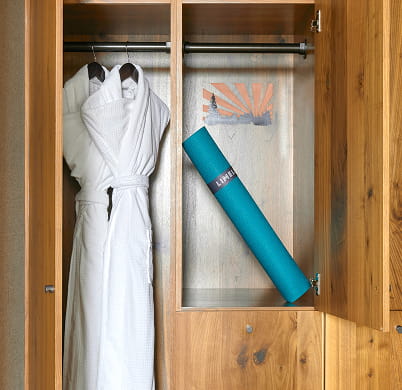 robes and yoga mat in room closet