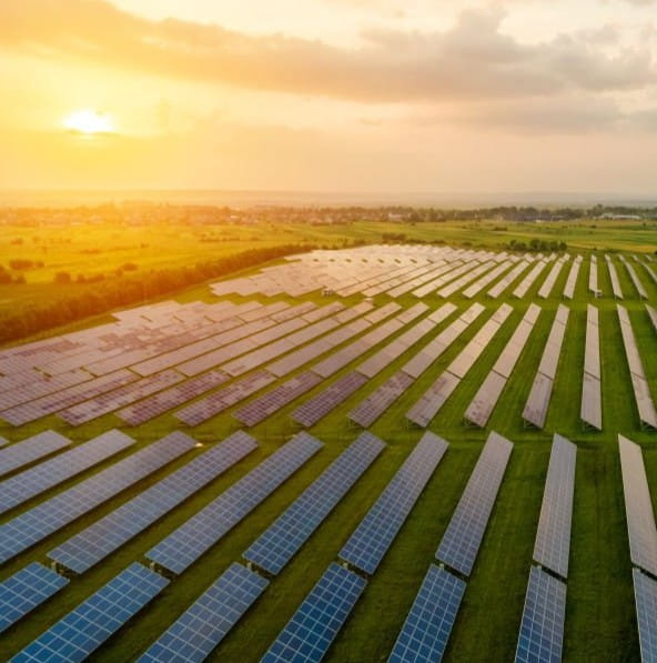 Aerial view of a solar farm at sunset