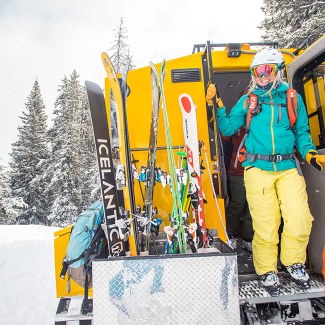 skier smiling getting off snow cat