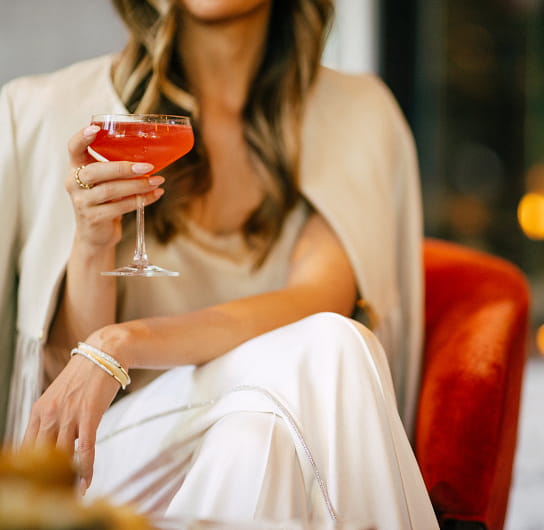 woman holding cocktail glass