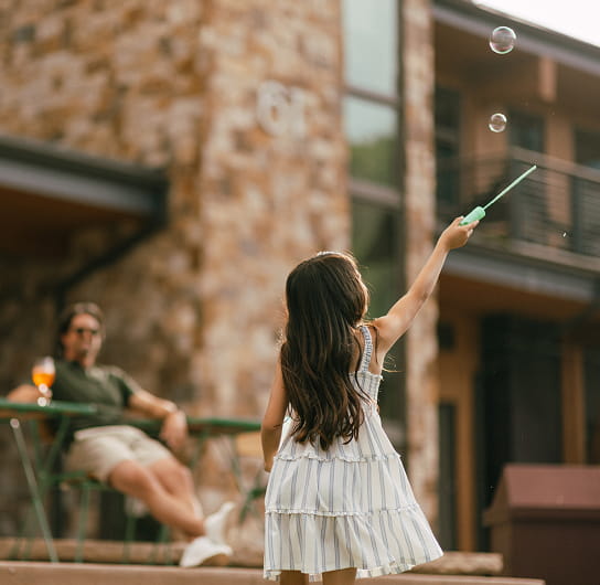 little girl playing with bubbles
