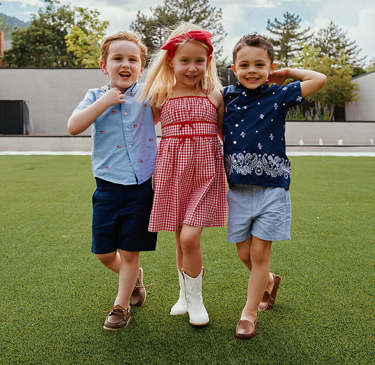 three kids walking on the snowmass lawn