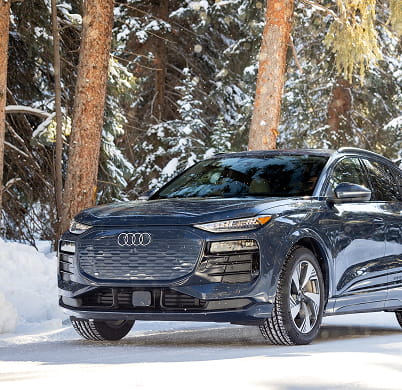 audi car driving in forest in winter