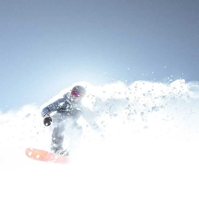snowboarder skiing powder