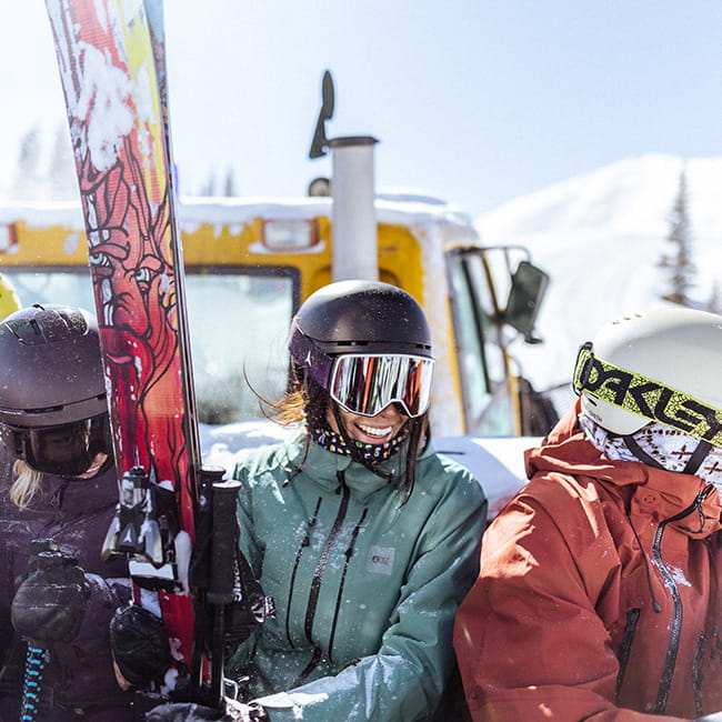 Three skiers smiling