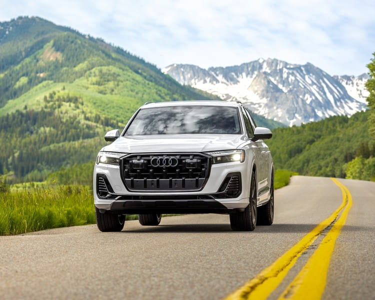 White Audi SUV car on a mountain road in Colorado