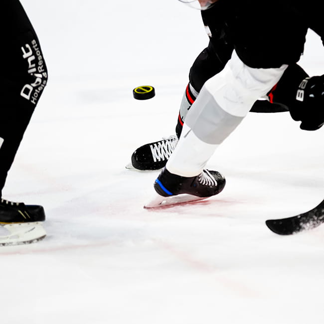 hockey players battling for puck