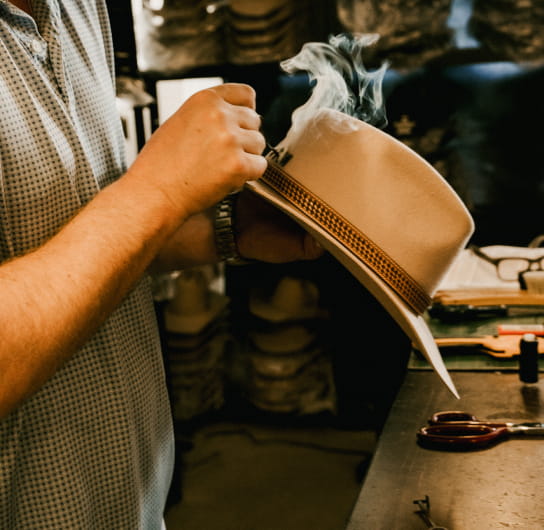 person making cowboy hat