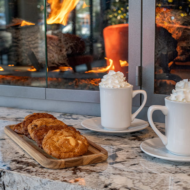 Cookies and hot cocoa by a fireplace