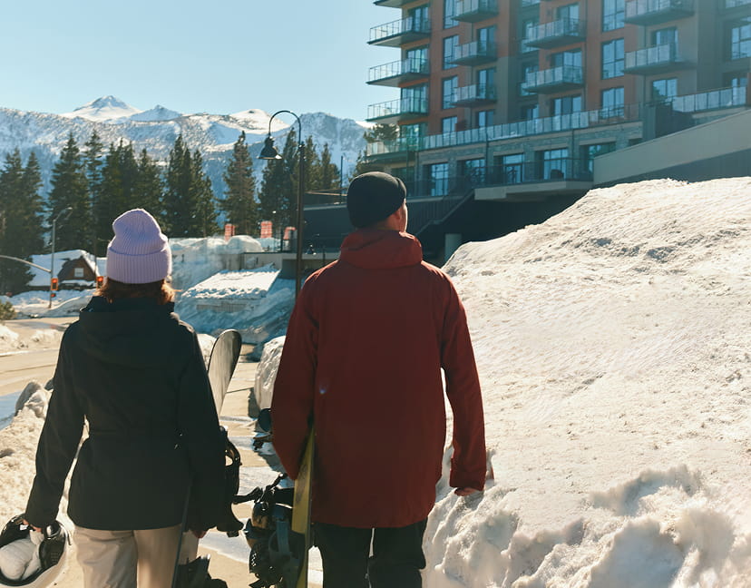 snowboarders in front of hotel