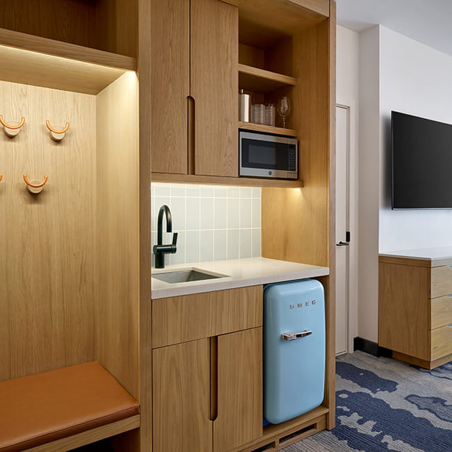 kitchenette, storage space, and tv in guest rooms