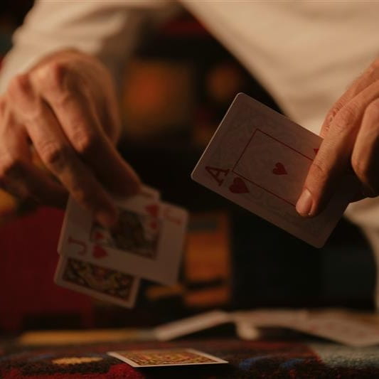 Close-up of person playing cards