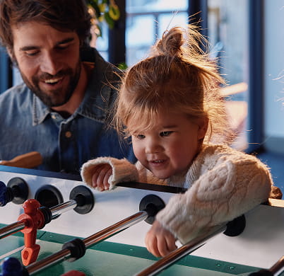 kid playing foosball