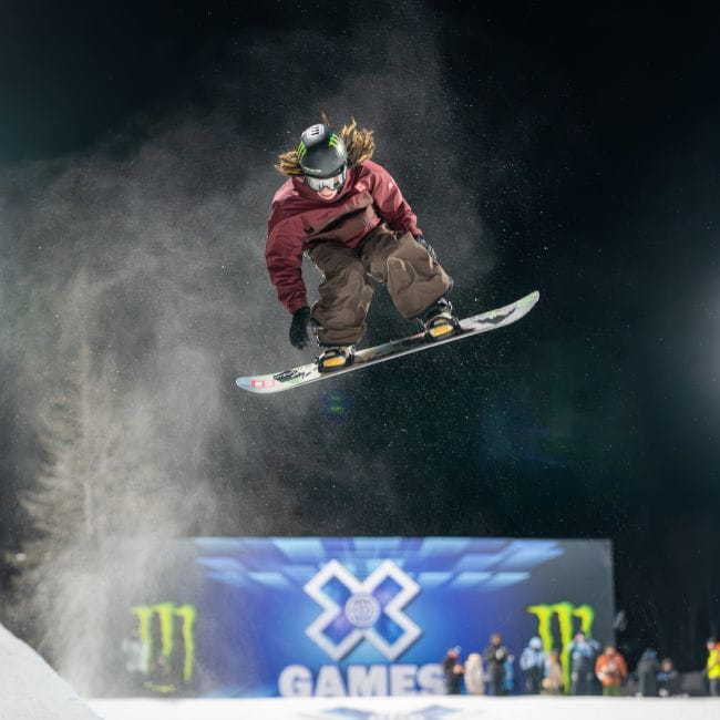 Snowboarder in the air at the X Games superpipe 