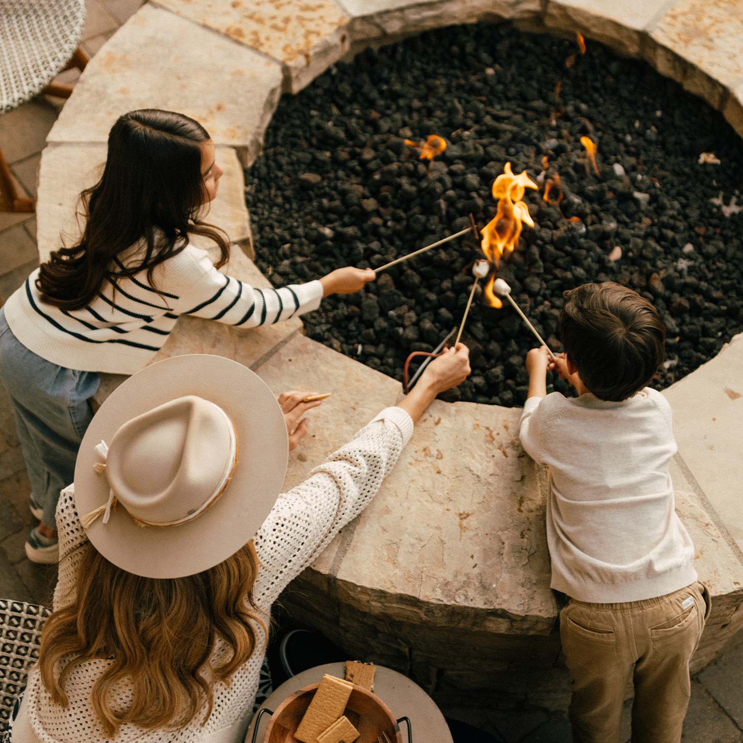 Family making s'mores at limelight snowmass