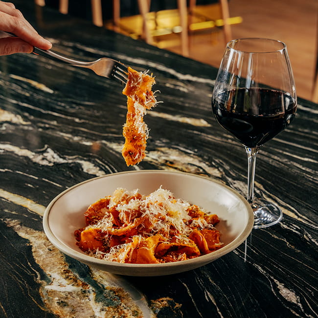 bowl of pasta and red wine